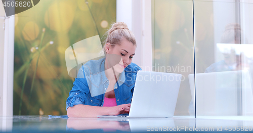Image of young women using laptop computer on the floor