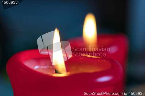 Image of Two red burning candels 