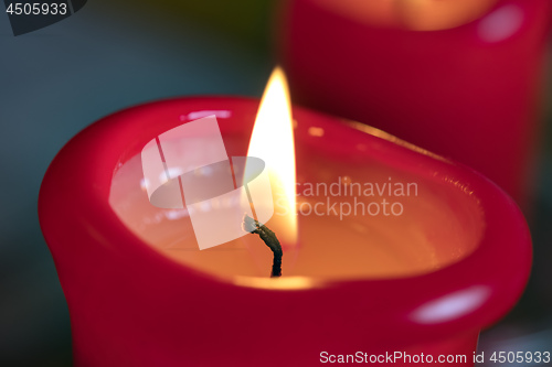 Image of Two red burning candels 