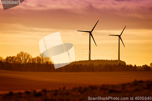 Image of Power Windmills with fields and trees