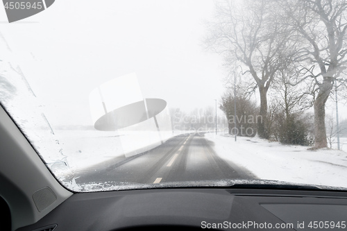 Image of View from a car to road with snow