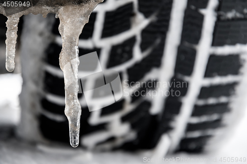 Image of closeup of a tyre of a car with icicle