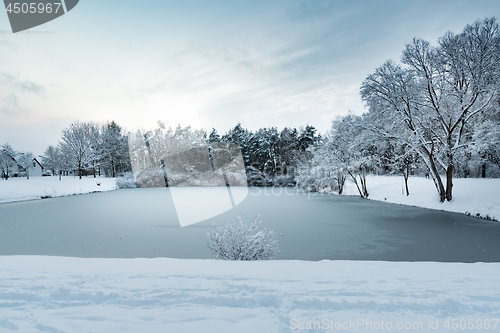 Image of Image of a pond with trees and heavy snow in village Gernlinden