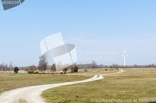 Image of Beautiful landscape with a winding road to a windmill