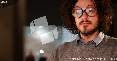 Image of man working on computer in dark office