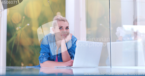 Image of young women using laptop computer on the floor