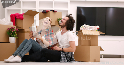 Image of young couple moving  in new house