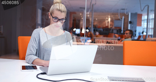 Image of businesswoman using a laptop in startup office