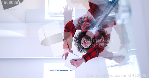 Image of young man using a tablet at home