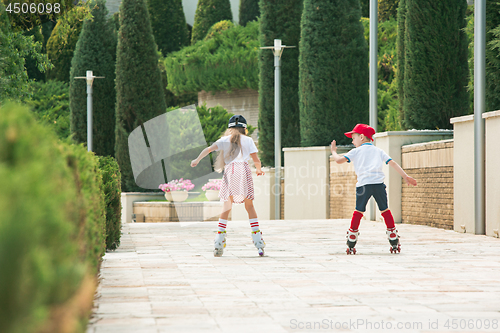 Image of Portrait of a charming teenage couple roller-skating together