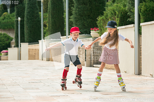 Image of Portrait of a charming teenage couple roller-skating together