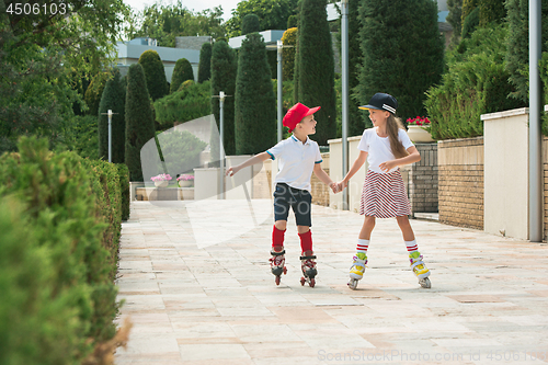 Image of Portrait of a charming teenage couple roller-skating together