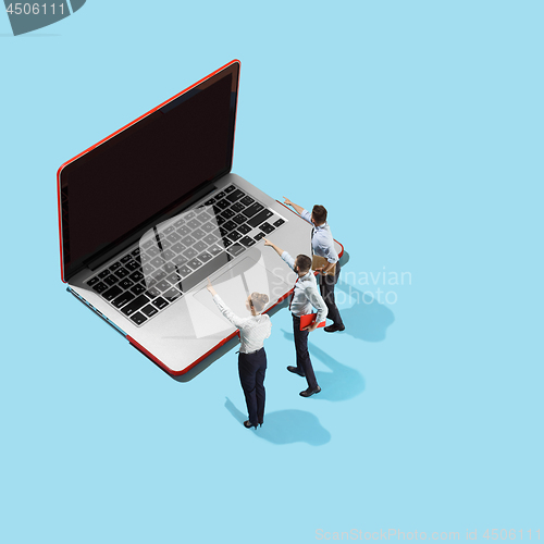Image of Flat isometric view of businessmen and woman showing at laptop with empty screen.