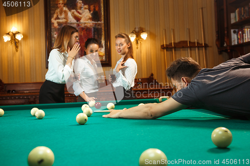 Image of Close-up shot of a man playing billiard