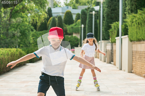 Image of Portrait of a charming teenage couple roller-skating together