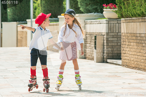 Image of Portrait of a charming teenage couple roller-skating together