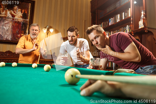 Image of Close-up shot of a man playing billiard