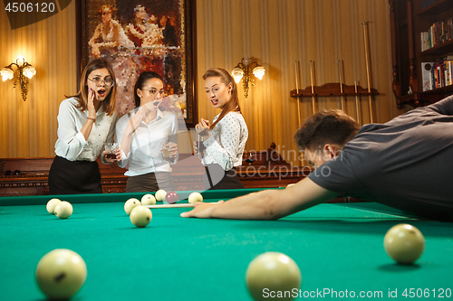 Image of Close-up shot of a man playing billiard