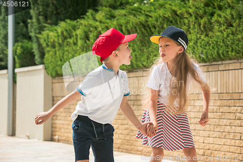 Image of Portrait of a charming teenage couple roller-skating together