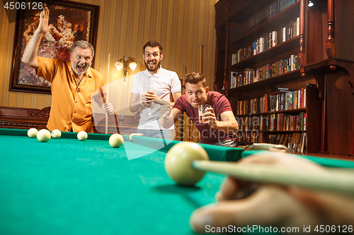 Image of Close-up shot of a man playing billiard