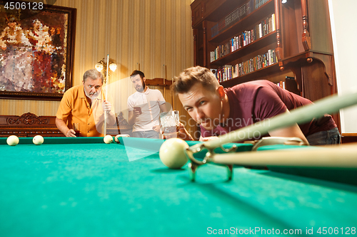 Image of Close-up shot of a man playing billiard