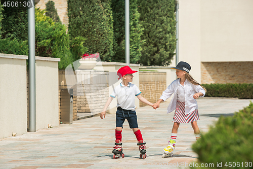 Image of Portrait of a charming teenage couple roller-skating together