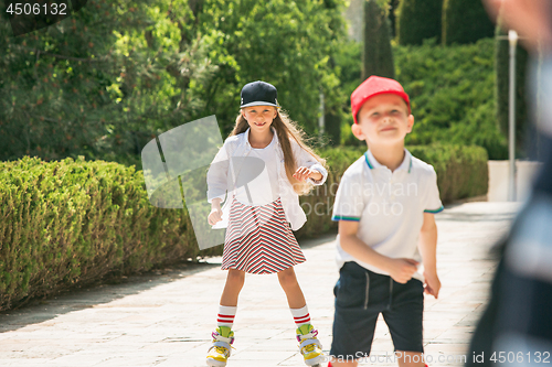 Image of Portrait of a charming teenage couple roller-skating together