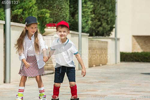 Image of Portrait of a charming teenage couple roller-skating together