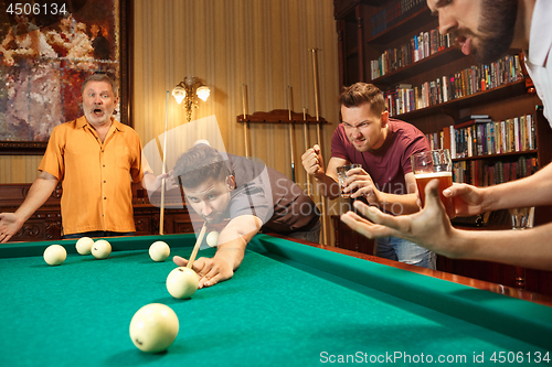 Image of Close-up shot of a man playing billiard