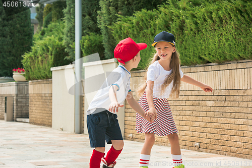 Image of Portrait of a charming teenage couple roller-skating together