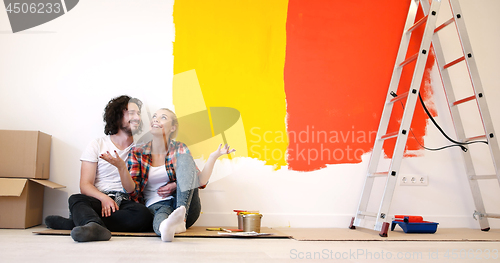 Image of Happy young couple relaxing after painting
