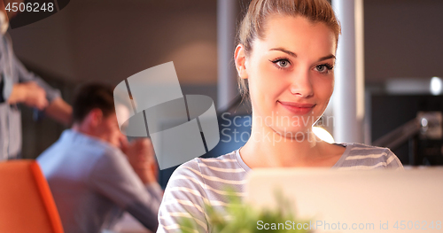 Image of businesswoman using a laptop in startup office