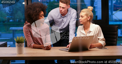 Image of Multiethnic startup business team in night office