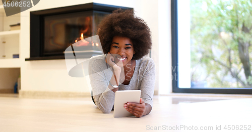 Image of black women using tablet computer on the floor