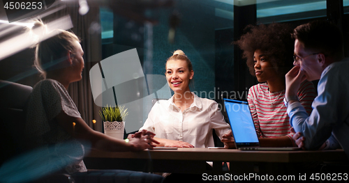 Image of Multiethnic startup business team in night office