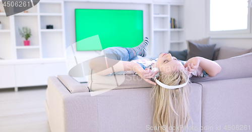 Image of girl enjoying music through headphones