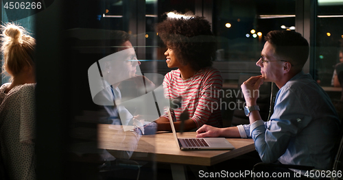 Image of Multiethnic startup business team in night office