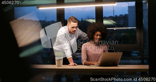 Image of Multiethnic startup business team in night office