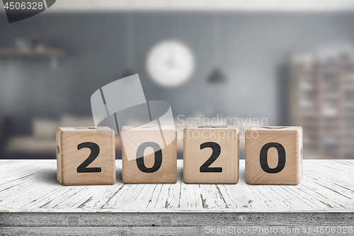 Image of Year 2020 sign on a wooden desk in a cozy kitchen