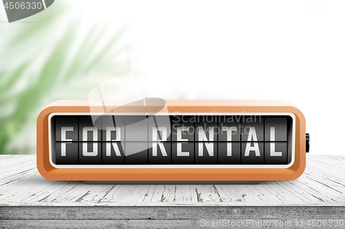 Image of For rental text on an analog device in orange color