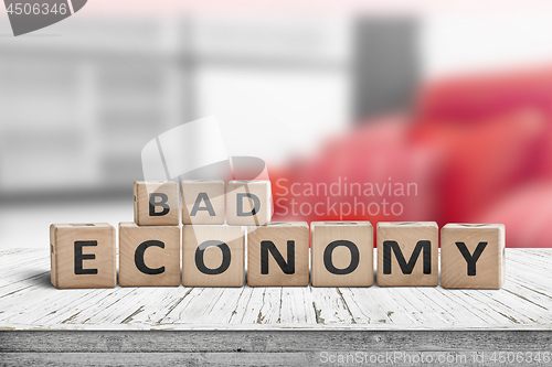 Image of Bad economy sign on a wooden desk in an office