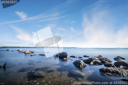 Image of Rocks by the ocean in the calm water