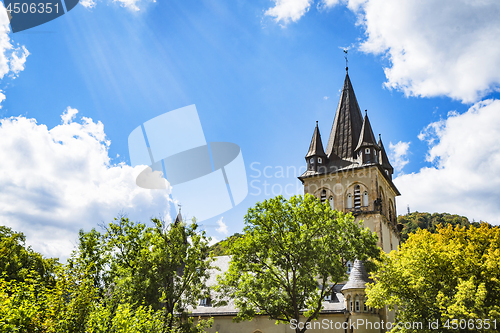 Image of Castle tower in a forest under a blue sky