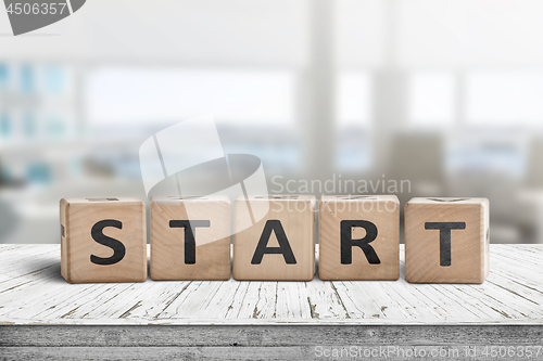 Image of Start sign in a bright office on a wooden table