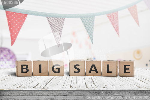 Image of Big sale sign on a white table with festive flags