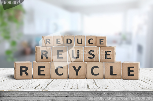 Image of Reduce, reuse and recycle sing on a wooden desk