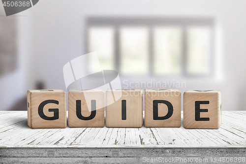 Image of Guide sign made of wood on a desk in a bright room