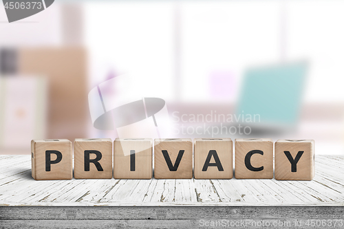 Image of Privacy sign on a wooden table in a bright room
