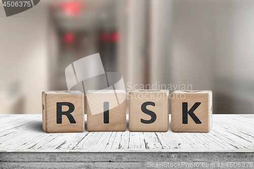 Image of Risk sign on a wooden desk with red lights