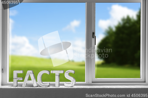 Image of Facts decor sign in a window with a green meadow